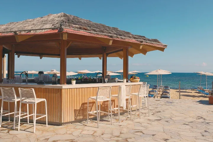 Beach Bar with white pergola overlooking Gulf of Malia